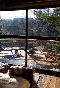 View out of the hangar windows and deck of the Maine solar powered treehouse.