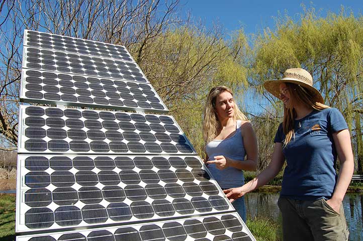 Two women learning about solar panels